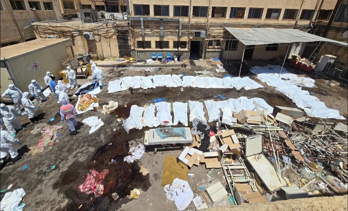 Bodies of massacre victims covered in white shrouds outside Suwayda National Hospital after a deadly attack in July 2025.